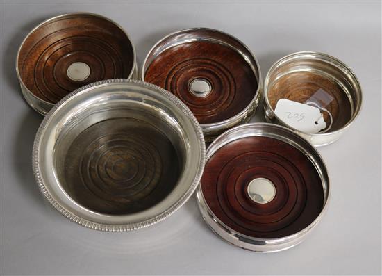 Five assorted modern silver mounted wine coasters, of varying sizes, largest 16.6cm.